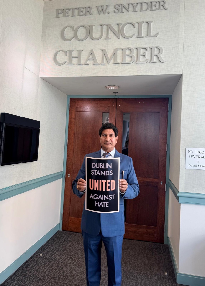 Shivraj Singh holding "Dublin Stands United Against Hate" sign outside Peter W. Snyder Council Chamber