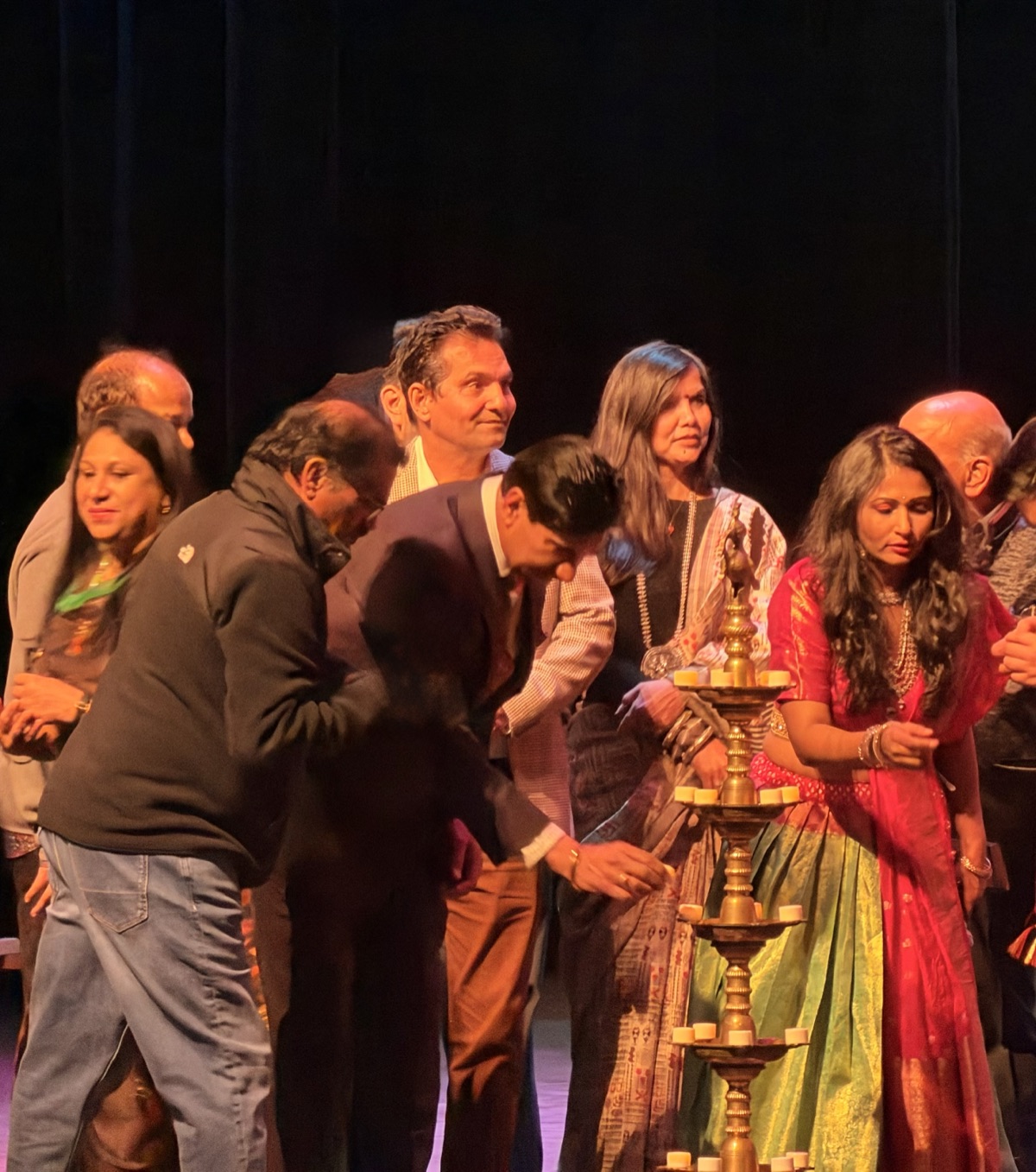 Shivraj Singh participating in a lamp lighting ceremony on stage with community leaders